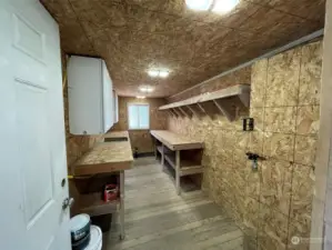 Room used for canning fruits and vegetables with cabinets and storage space. Lights run off of solar panels.