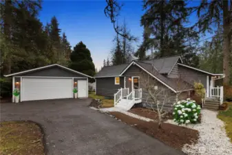 Drive into your own private 0.3 acre wonderland, with oversized two car garage to the left and charming cottage-style home to your right! NB. The hydrangea bush has been digitally enhanced.