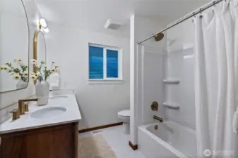 The remodeled shared bathroom features a MCM inspired vanity.