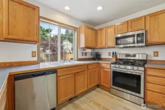 Kitchen with stainless steel appliances and new Luxury plank flooring.