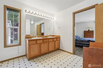 Spacious Primary bedroom ensuite with dual sinks, and walk-in closet.