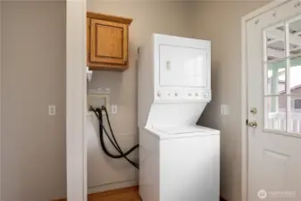 Laundry room with freezer space and washer and dryer that are included in the home.