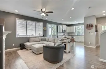 View of your family room from the fireplace to the kitchen, lots of windows and the patio doors let in all the light.