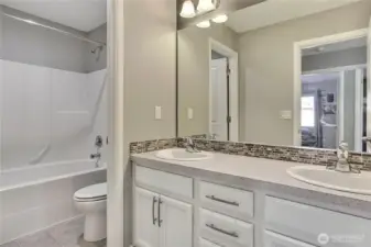 Upstairs kids/guest full bath. I love the double vanity and separate water closet/shower room so 2 can use it at the same time. Nice tilework around the sink as well.