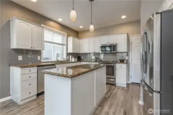 Crisp white cabinets, granite counters, stainless steel appliances