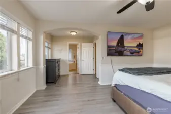 Primary suite has large windows, arched doorway