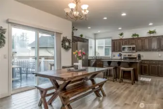 Dining room and kitchen feature beautiful and durable wood-look tile flooring