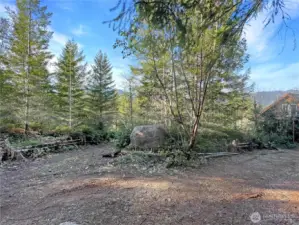 Just off street. Right is driveway to house. Left is driveway to the lower level. Nice rock to engrave name or ?