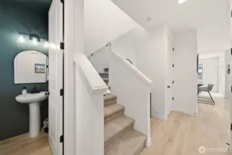 Interior Entrance. Main level half bathroom. Stair case to upper level.