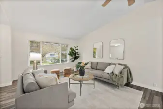 Living room is situated off the entryway with huge window bringing in lots of natural light. Watch the trees in the front change with the seasons.