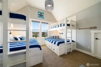 View of upper level bedroom with built-in twin over queen bunk beds.