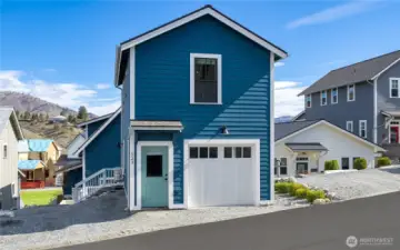 Exterior view 2 of parking area and 1-car garage carriage house.