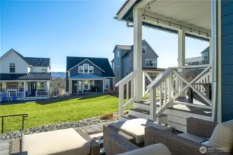 Exterior view of home with outdoor living space and classic covered porch fronting Vineyard Park.