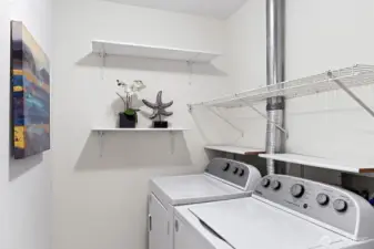 Laundry room with full sized washer and dryer. Lots of potential storage!