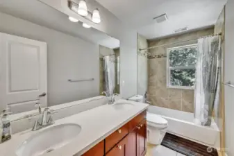Full bathroom with double sign on upper level