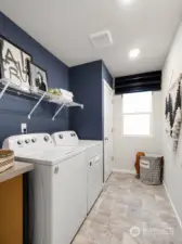 Upstairs Laundry Room with Shelving and Folding Table - Photos are for representational purposes only. Colors and options may vary.