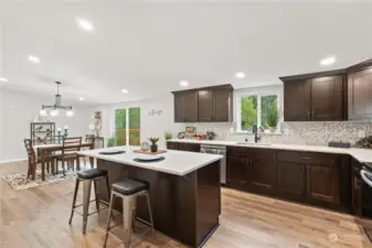 Kitchen w/Eating Bar Island, Recessed Lighting and Window overlooking the backyard.