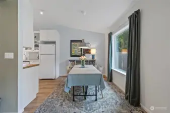 Dining area enjoys a big picture window to the back yard.