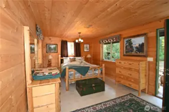 Main level bedroom with access to your private deck. *Montana log furniture included.