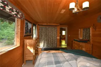 Opposite angle of the spacious bdrm ~ plenty of closet storage and a view of the forested landscape.