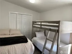 1. Bedroom with a queen size bed and a bunk bed