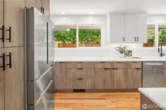 Light-filled kitchen with an abundance of storage. Water dispenser locterd inside refrigerator.