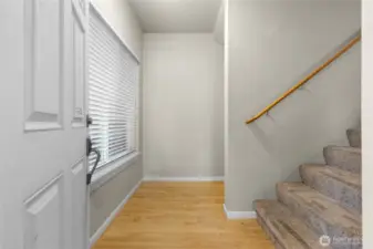 Foyer with hardwood floors and window on left-great light flow in this home!