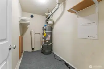 Storage closet in basement with water heater