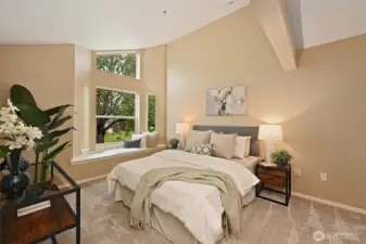 The Primary Suite with its vaulted ceilings and a flood of natural light beckons you to relax and recharge.