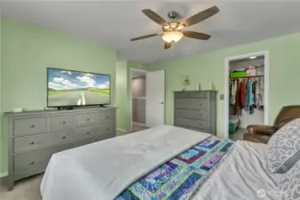 Walk in closet and ceiling fan in the primary