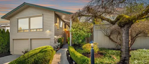 Welcome to one of West Houghton's finest addresses — a serene cul-de-sac with breathtaking west-facing views of the snow-capped Olympic Mountains and spectacular sunsets. The Cross Kirkland Corridor trail is half a block away, with Houghton Beach Park, Carillon Point, Lake Washington, Google Campus, downtown Kirkland, Metropolitan Market, and Lakeview Elementary all within blocks.  Inside, a fully reimagined primary suite features a spa-caliber bath, custom tile, and walk-in closet with built-ins. The updated kitchen boasts a large island and Viking 6-burner gas cooktop, opening to a generous deck and private backyard — flat, fully usable, with lush lawn, mature landscaping, and built-in garden beds. Three gas fireplaces add warmth throughout.  Downstairs, a bedroom, ¾ bath, and oversized rec room offer compelling MIL conversion potential. Light, airy, and lovingly curated.