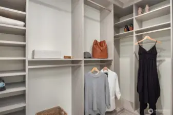 A generously sized, newly updated walk-in closet featuring a thoughtfully designed built-in system with dedicated hanging space, shelving, and storage at every turn — a beautifully organized retreat that brings effortless order and elegance to daily living.
