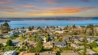 A stunning aerial view perfectly illustrating the home's unbeatable location — with the Cross Kirkland Corridor trail and the glistening waters of Lake Washington both just blocks away, nestled within a serene, tree-lined neighborhood that offers the rare combination of nature, recreation, and community right outside the front door.