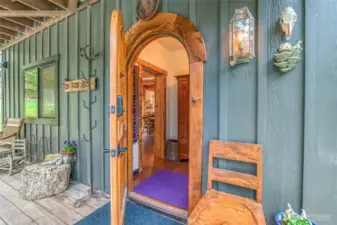The door opens into a light filled entry, featuring a window and a charming armoire.