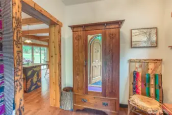 From the entry, a charming armoire adds warmth, with a welcoming view into the home.
