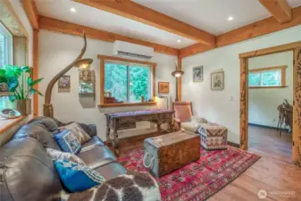 Another view of the living room with a bedroom in the background.