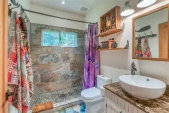 Downstairs bathroom with a custom tile shower, window, and nice natural light.