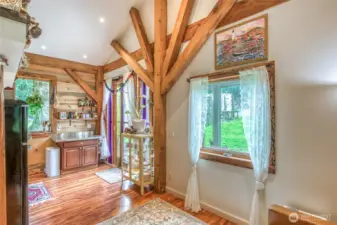 Beautiful sunburst pattern of beams at the kitchen entry, with lovely windows for soft light.