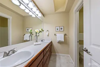 Hallway bath on upper level with dual vanity.