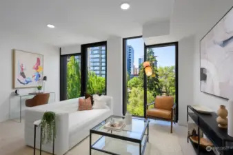 Living area features operable floor-to-ceiling windows, engineered hardwoods, ceiling Mitsubishi mini-split, and ample space for a home office.