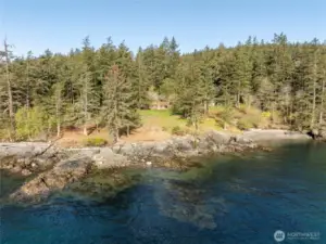 Stunning waterfront acreage with over 800 feet of shoreline, vintage cabin and cove beach.