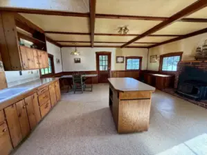 Cozy, vintage cabin with kitchen, dining and living room space.