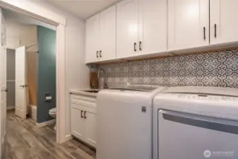 Updated laundry room with utility sink - access to back yard