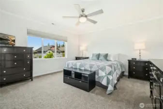 Primary suite bedroom with ceiling fan.