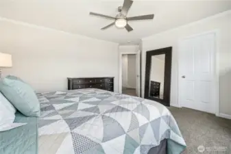 Primary suite bedroom with ceiling fan.