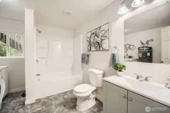 This bathroom is also home to the utility room.