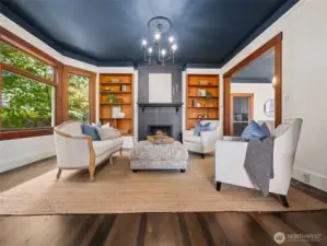 Cozy fireplace living room, beautiful window views, and built-in shelves.