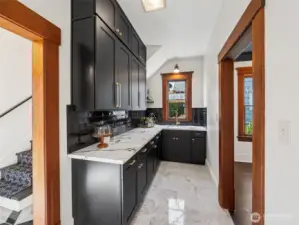 Side pantry is a hosts dream with moody colors and plenty of counter space.