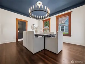 Large dining room with grand light fixture.