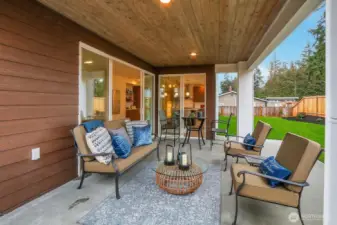 The covered outdoor living space ensures comfort in every season.